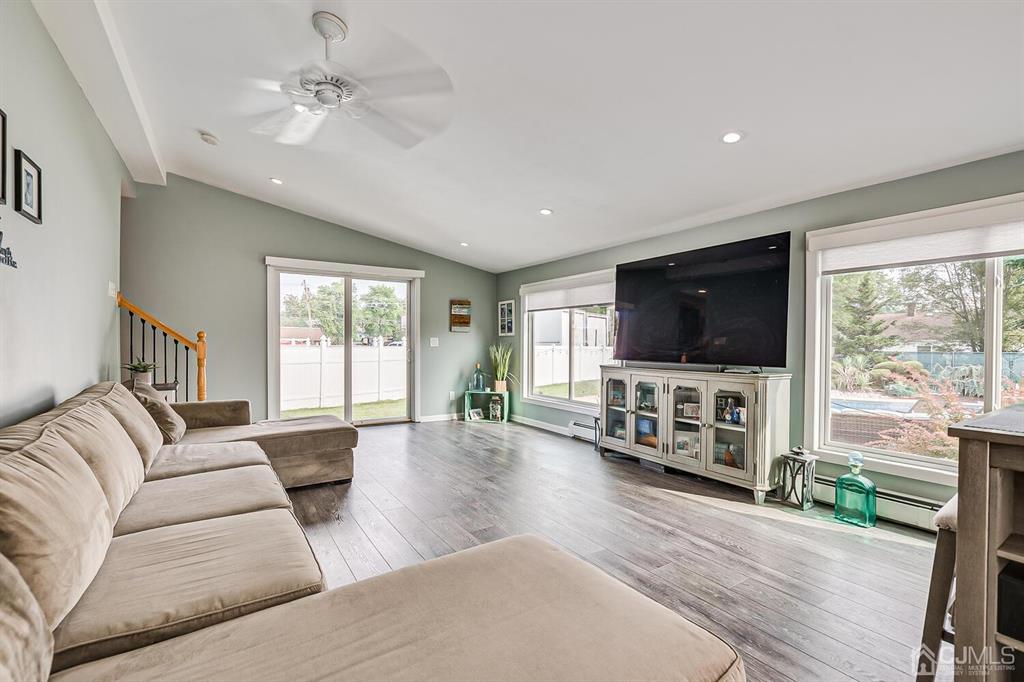 13 Highfield Road Colonia, NJ 07067 - Photo 18 of 42 a living room with furniture and a flat screen tv