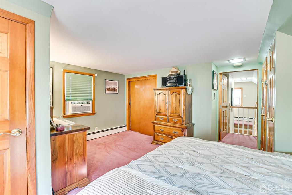 13 Highfield Road Colonia, NJ 07067 - Photo 23 of 42 a bedroom with a bed and wooden floor