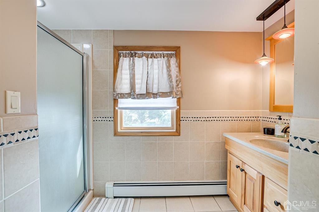 13 Highfield Road Colonia, NJ 07067 - Photo 24 of 42 a bathroom with a sink and a mirror