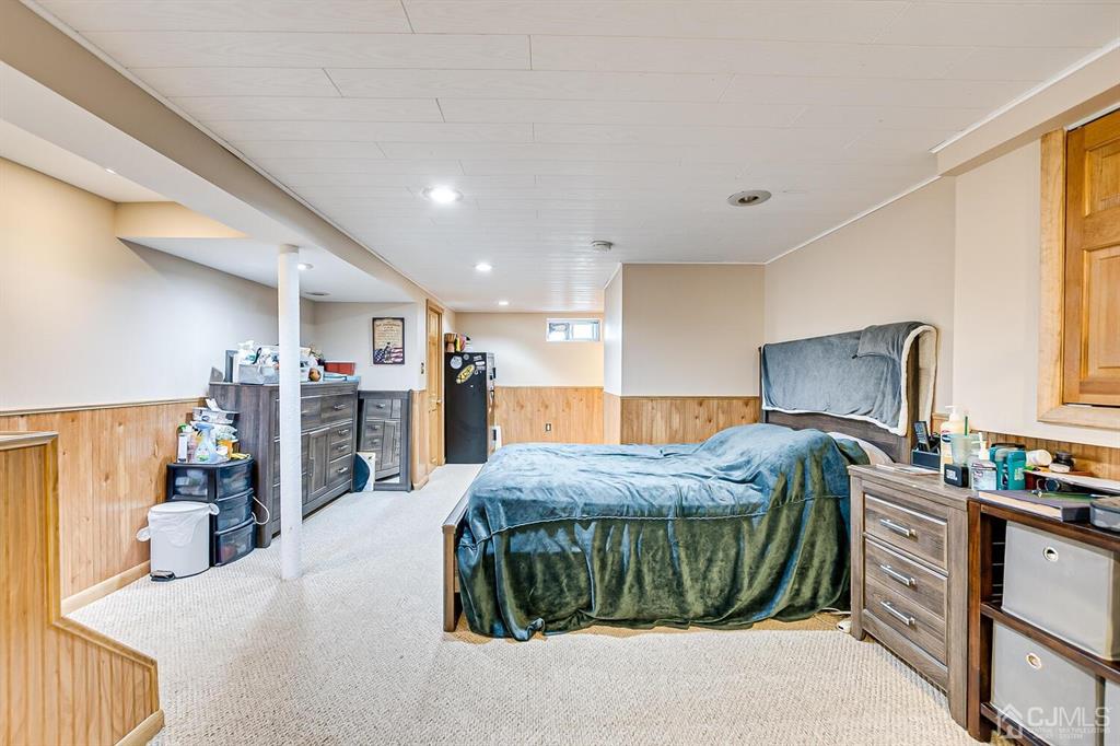 13 Highfield Road Colonia, NJ 07067 - Photo 26 of 42 a bed room with a bed and a television