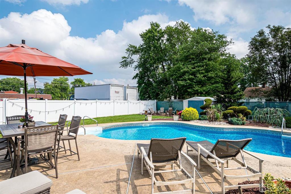 13 Highfield Road Colonia, NJ 07067 - Photo 31 of 42 a view of a swimming pool with chair and tables