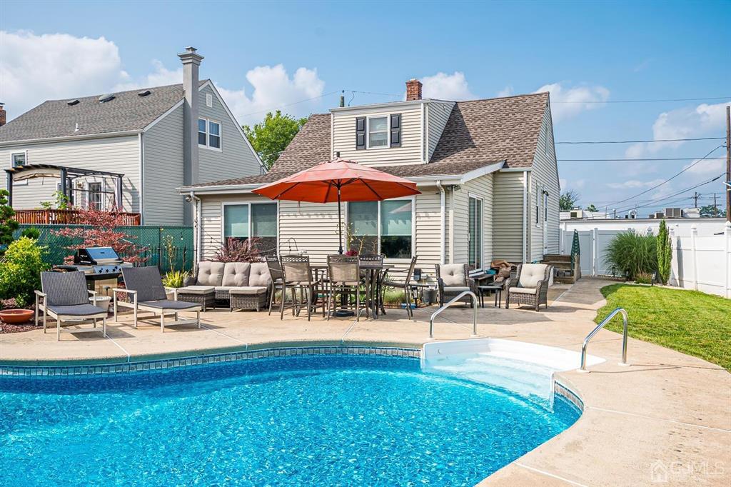 13 Highfield Road Colonia, NJ 07067 - Photo 34 of 42 a front view of a house with swimming pool and sitting area