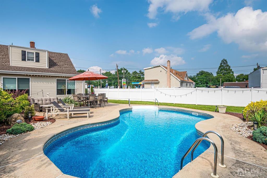13 Highfield Road Colonia, NJ 07067 - Photo 35 of 42 a swimming pool with outdoor seating and yard