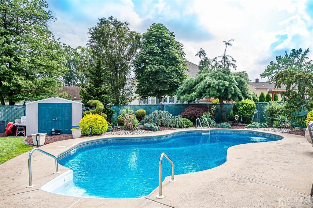 13 Highfield Road Colonia, NJ 07067 - Photo 36 of 42 a view of a swimming pool with a patio and plants