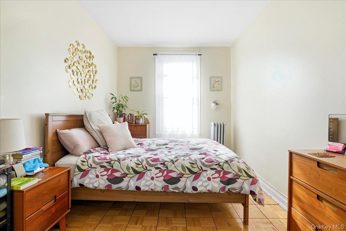 60-58 60th Road Queens, NY 11378 - Photo 11 of 25 a bedroom with a bed and a tv in it