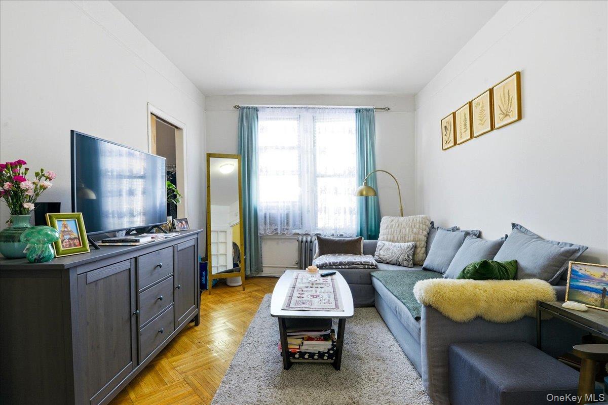 60-58 60th Road Queens, NY 11378 - Photo 13 of 25 a living room with furniture and a flat screen tv