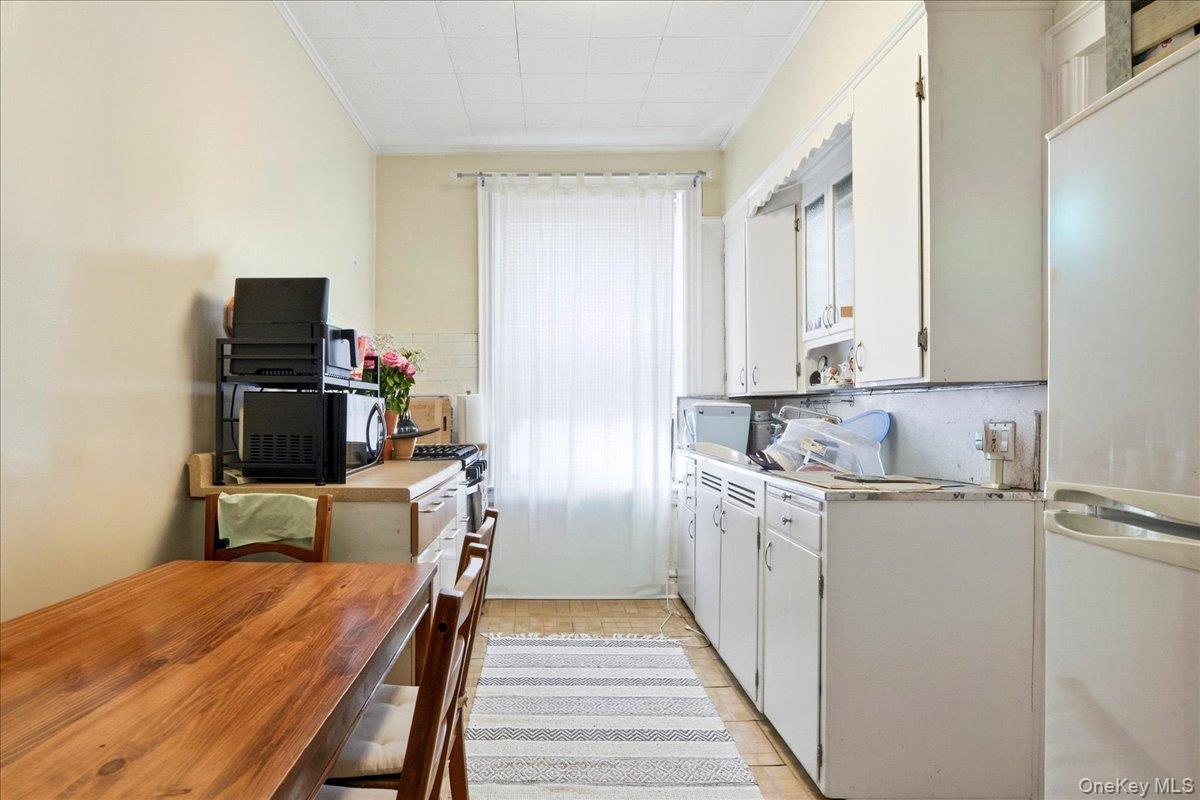 60-58 60th Road Queens, NY 11378 - Photo 15 of 25 a kitchen with a sink appliances and cabinets