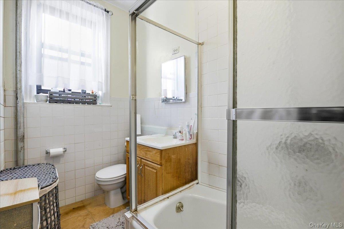 60-58 60th Road Queens, NY 11378 - Photo 17 of 25 a bathroom with a sink a toilet and shower