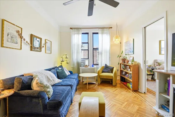 a living room with furniture and large windows