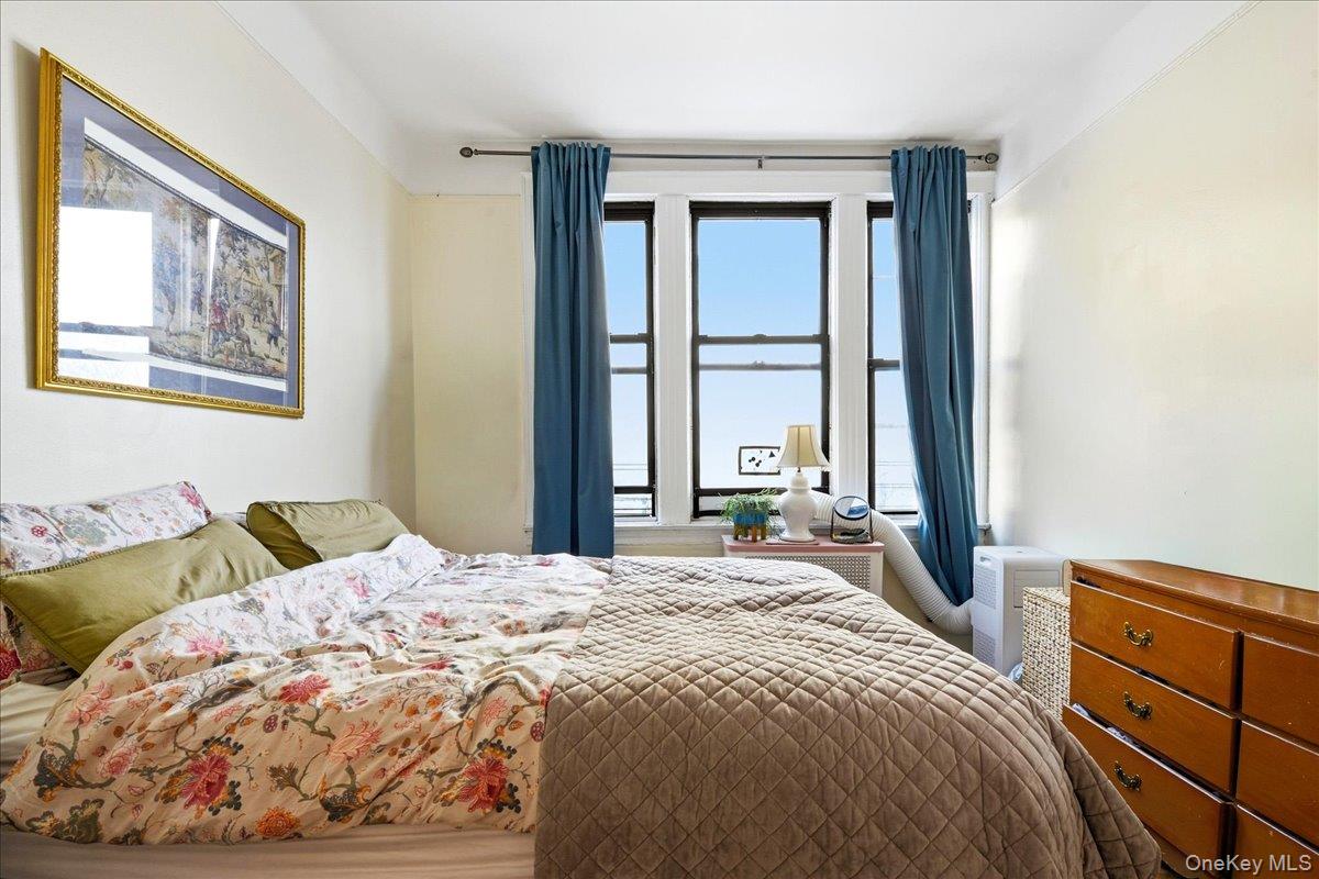 60-58 60th Road Queens, NY 11378 - Photo 8 of 25 a bedroom with a bed and a window