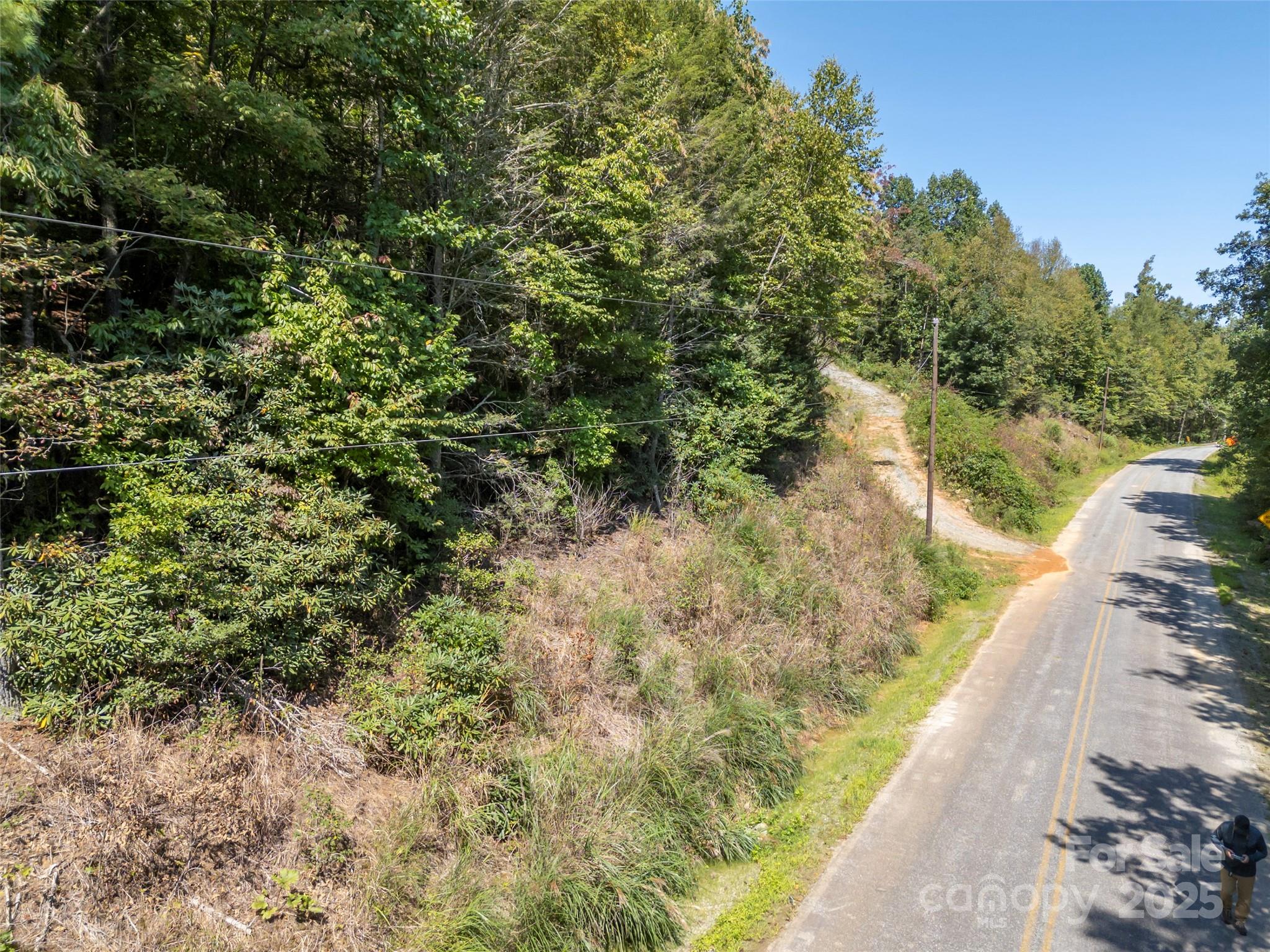 0 Camp Creek Road Saluda, NC 28773 - Photo 35 of 37 a view of a lake with a house in the background