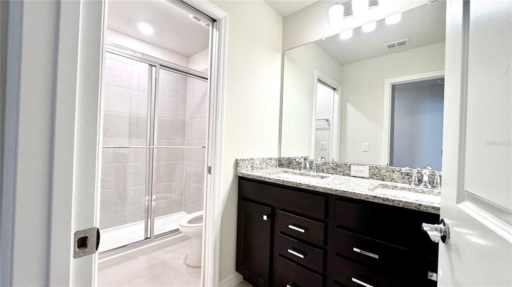 16248 St Kitts Circle Clermont, FL 34714 - Photo 13 of 27 a bathroom with a double vanity sink mirror and double