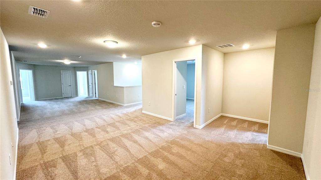 16248 St Kitts Circle Clermont, FL 34714 - Photo 14 of 27 a view of a big room with a bathroom