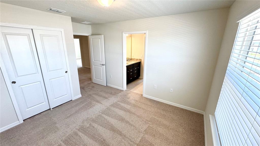 16248 St Kitts Circle Clermont, FL 34714 - Photo 18 of 27 an empty room with windows