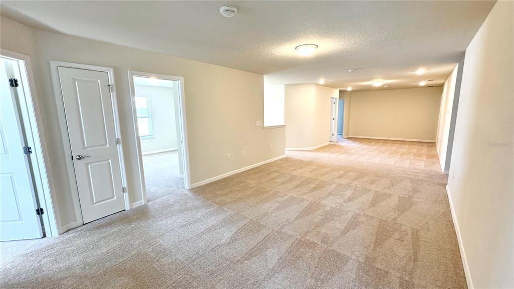 16248 St Kitts Circle Clermont, FL 34714 - Photo 19 of 27 an empty room with windows and bathroom view