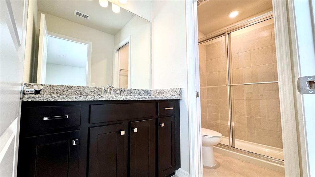 16248 St Kitts Circle Clermont, FL 34714 - Photo 21 of 27 a bathroom with a granite countertop sink and a mirror