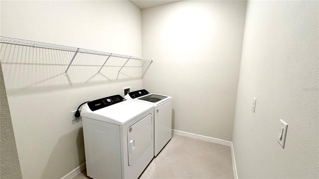 16248 St Kitts Circle Clermont, FL 34714 - Photo 5 of 27 a utility room with dryer and washer