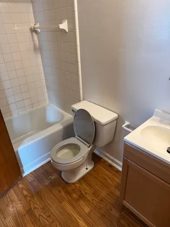 a bathroom with a toilet and a shower