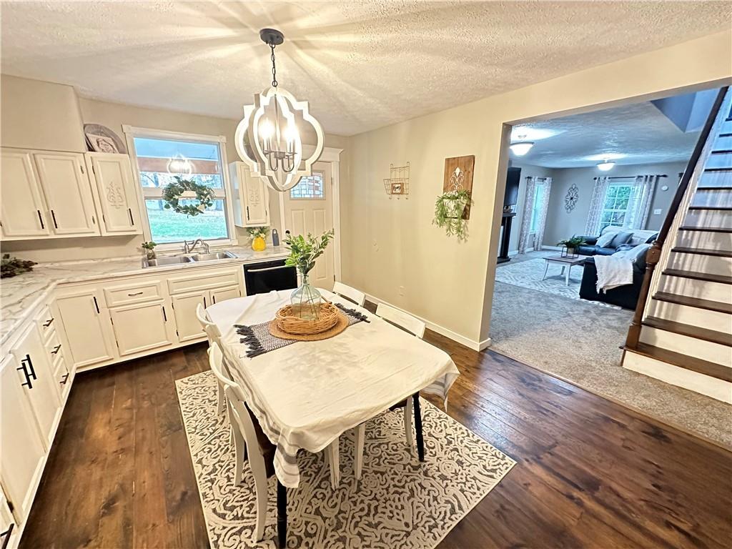 213 Fallen Timbers Road Point Marion, PA 15474 - Photo 5 of 16 a living room with furniture a dining table and a chandelier