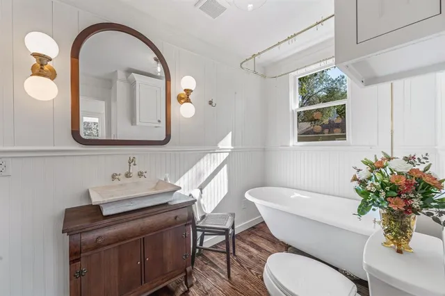 a bathroom with a toilet a sink and a mirror