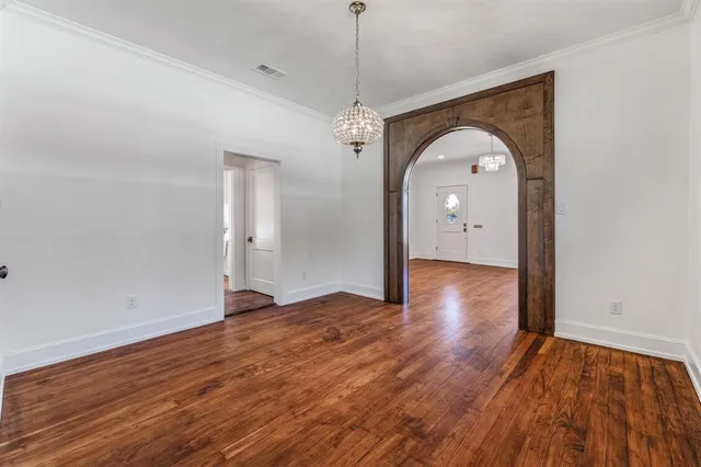 a view of a livingroom with wooden floor and window