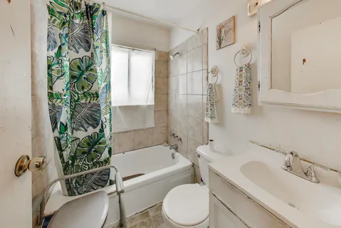 a bathroom with a sink a toilet a bathtub and shower
