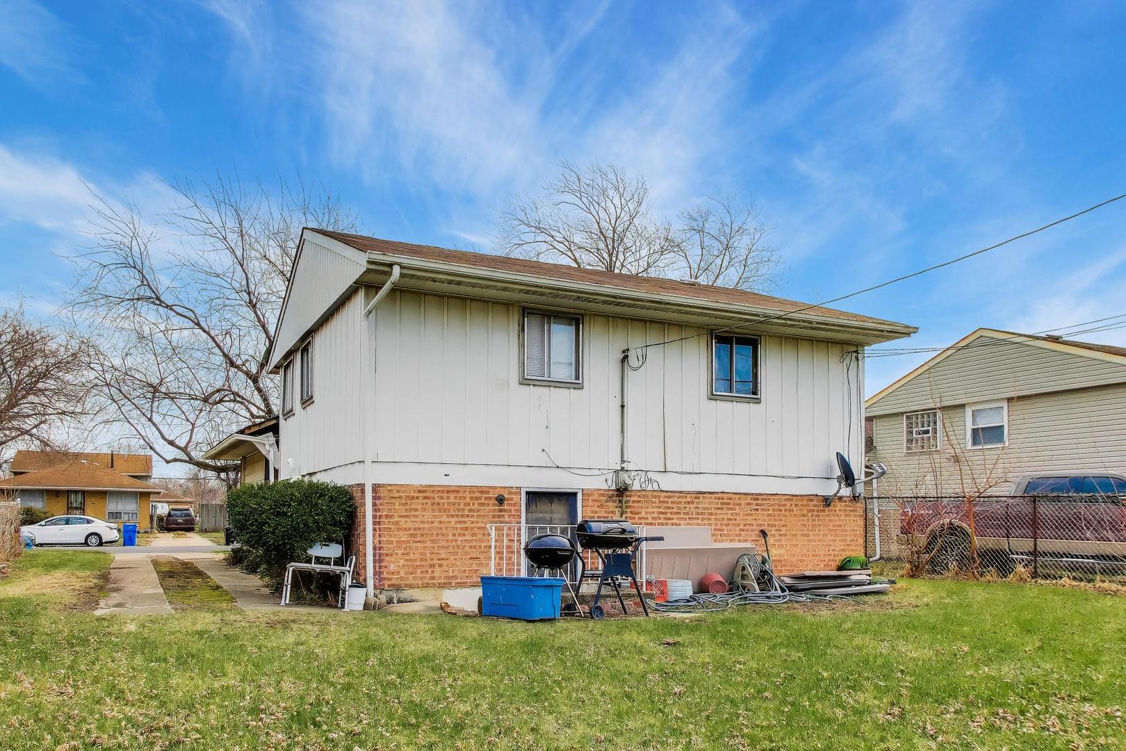 11746 South Racine Avenue Chicago, IL 60643 - Photo 18 of 24 a front view of a house with a yard