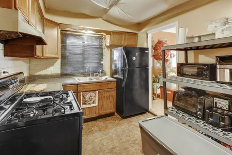 a kitchen with stainless steel appliances granite countertop a stove and a refrigerator