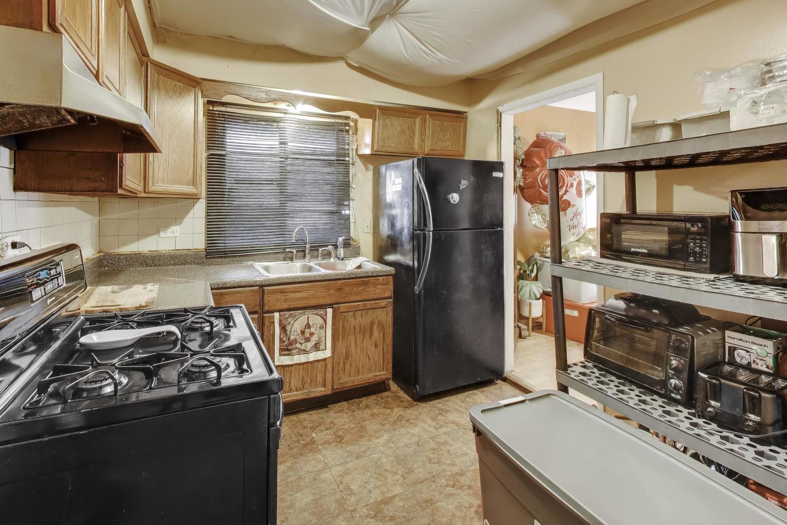 11746 South Racine Avenue Chicago, IL 60643 - Photo 7 of 24 a kitchen with stainless steel appliances granite countertop a stove and a refrigerator