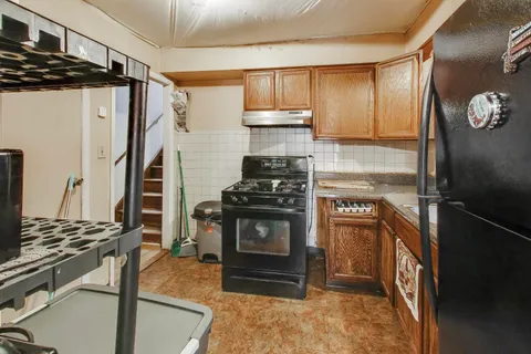 a kitchen with a refrigerator and a stove top oven