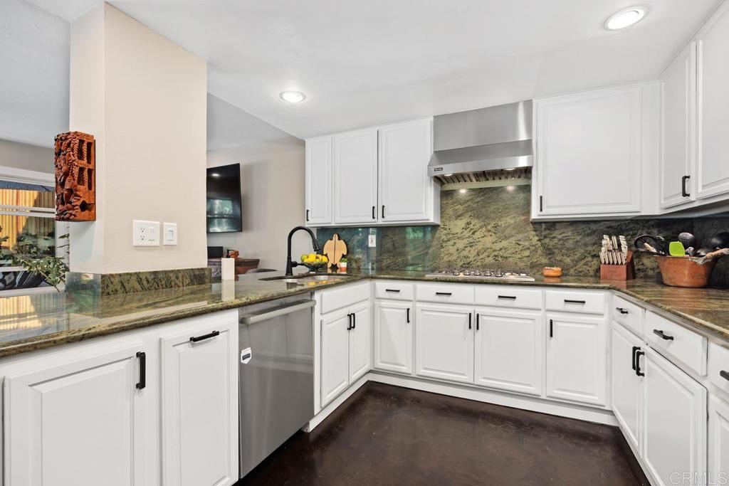3112 Del Rey Avenue Carlsbad, CA 92009 - Photo 11 of 34 a kitchen with granite countertop white cabinets and white appliances