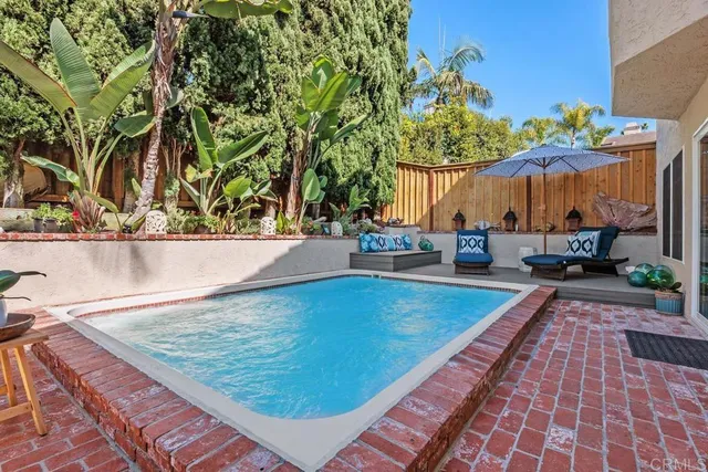 swimming pool view with a seating space