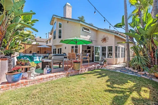 a view of a house with swimming pool and sitting area