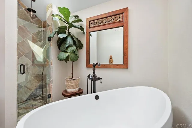 a bathroom with a sink a mirror and a shower