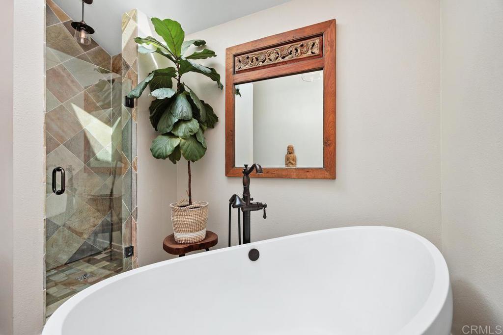 3112 Del Rey Avenue Carlsbad, CA 92009 - Photo 26 of 34 a bathroom with a sink a mirror and a shower