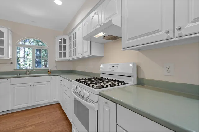 a kitchen with cabinets and window
