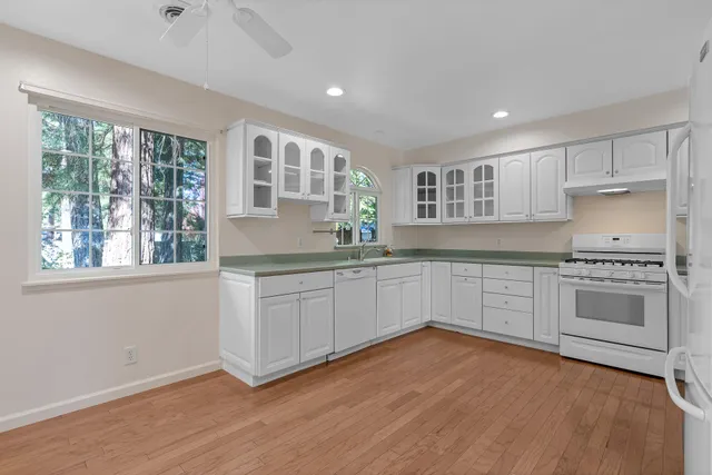 a kitchen with granite countertop a stove and cabinets