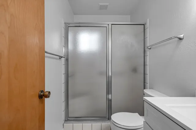 a bathroom with a toilet and a shower