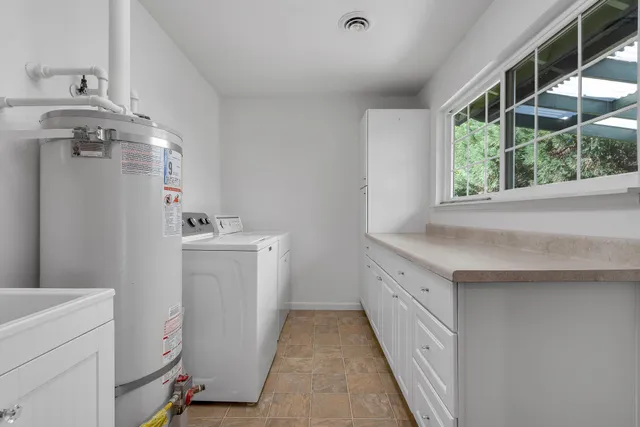 a bathroom with a sink a toilet and a window