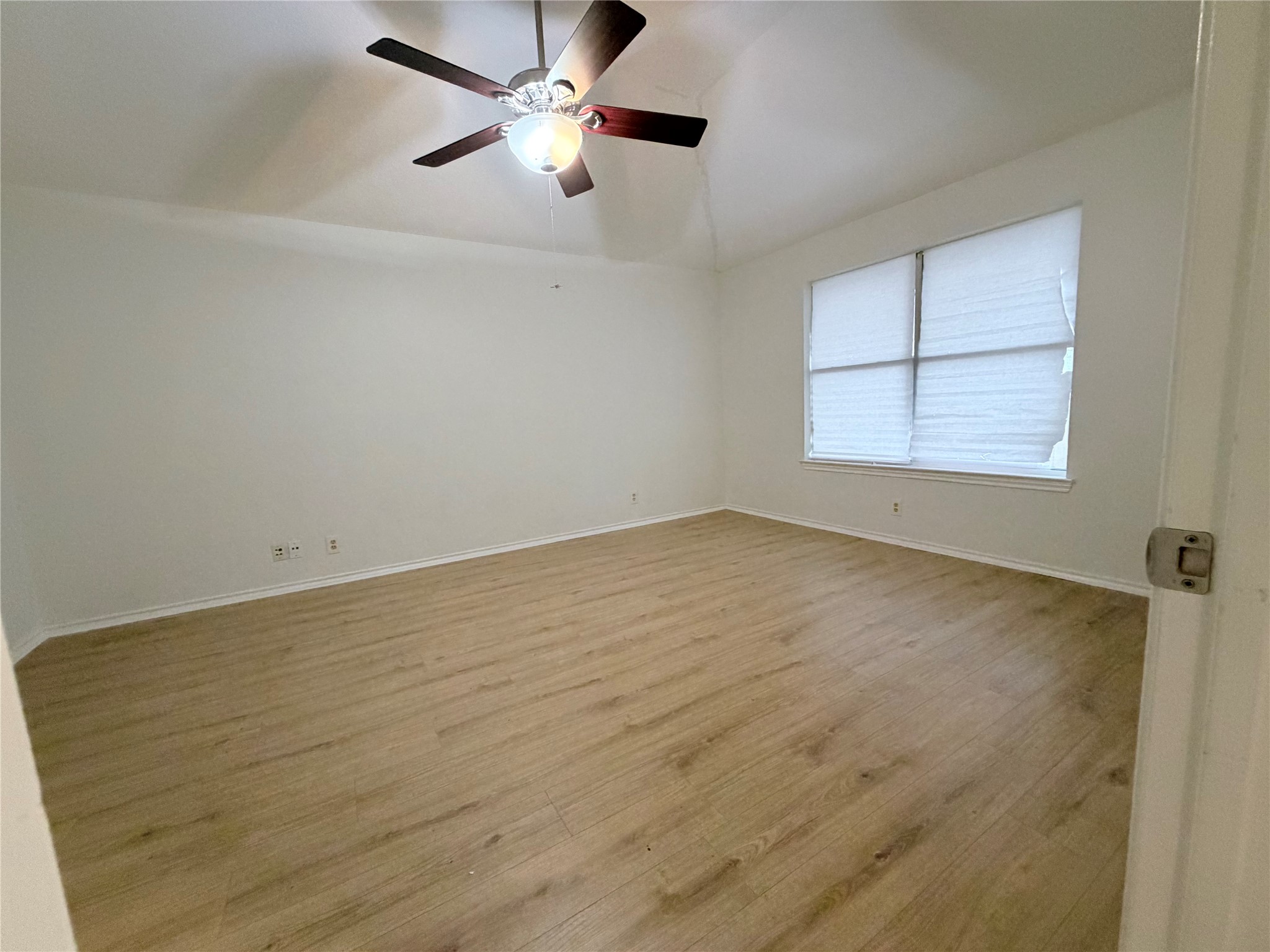 20809 Pacers Gait Lane Pflugerville, TX 78660 - Photo 12 of 23 Unfurnished room with wood finished floors, a ceiling fan, and lofted ceiling