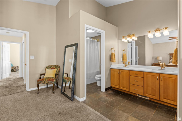 7824 South Sequoia Tree Lane Sandy, UT 84094 - Photo 22 of 43 Bathroom featuring double vanity, dark colored carpet, and shower / bath combination with curtain