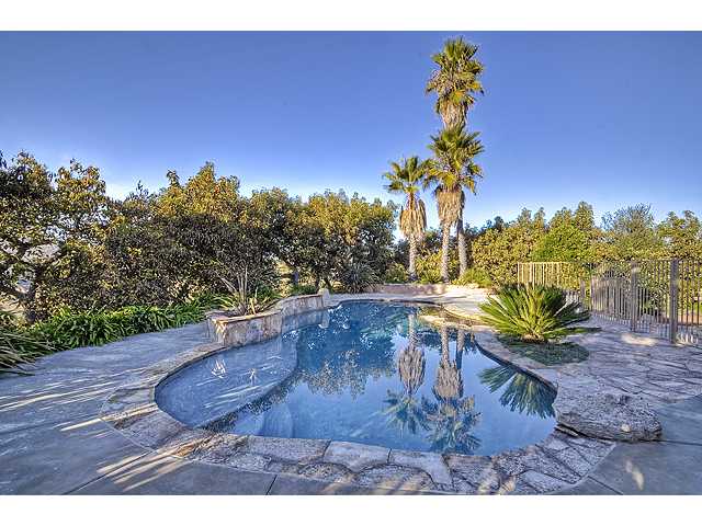 16591 Highland Valley Road Ramona, CA 92065 - Photo 15 of 25 Fully fenced, gradual beach entry pool. Lighted in the evening and offers waterfall ooption. Quartzite pool edge and deck. Pool pump refurbished December 2011. Solar blanket maintains pool heat~ AWESOME!