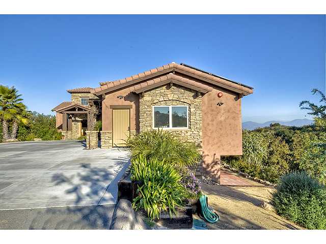 16591 Highland Valley Road Ramona, CA 92065 - Photo 3 of 25 Side view of the garage and sloping hillside that leads to 516 SqFt storage room~