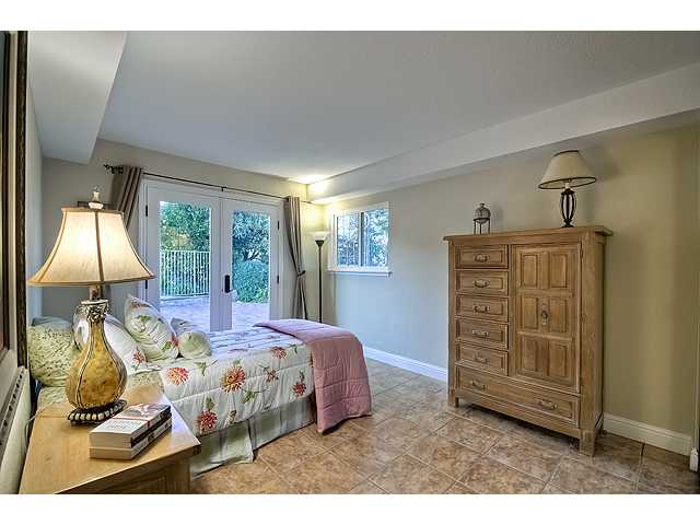 16591 Highland Valley Road Ramona, CA 92065 - Photo 23 of 25 The 4th of four bedrooms. Even the smallest bedrooms are not small and this bedroom has access to lower level patio area and pool~