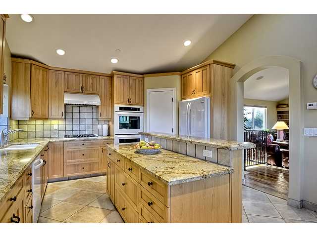 16591 Highland Valley Road Ramona, CA 92065 - Photo 9 of 25 Moving angles of thie kitchen. The door between the refrigerator and the double ovens leads to a spacious pantry.