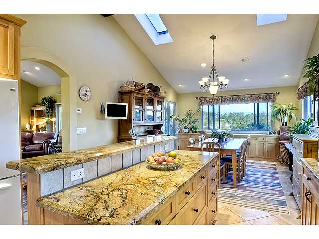 16591 Highland Valley Road Ramona, CA 92065 - Photo 10 of 25 Full on view of the entire kitchen, dining area and East facing view windows. Sliding glass doors lead you outdoors to 1st level of two-tiered balcony. PERFECt for year round outside dining!