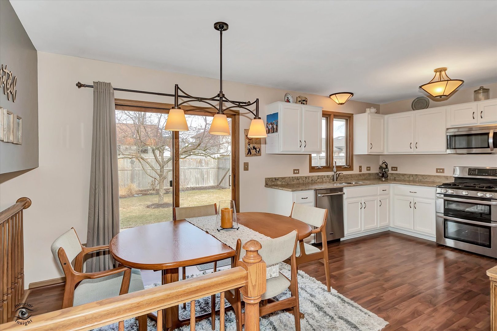 2909 Bisbee Drive Joliet, IL 60432 - Photo 6 of 23 a kitchen with a table chairs stove and cabinets
