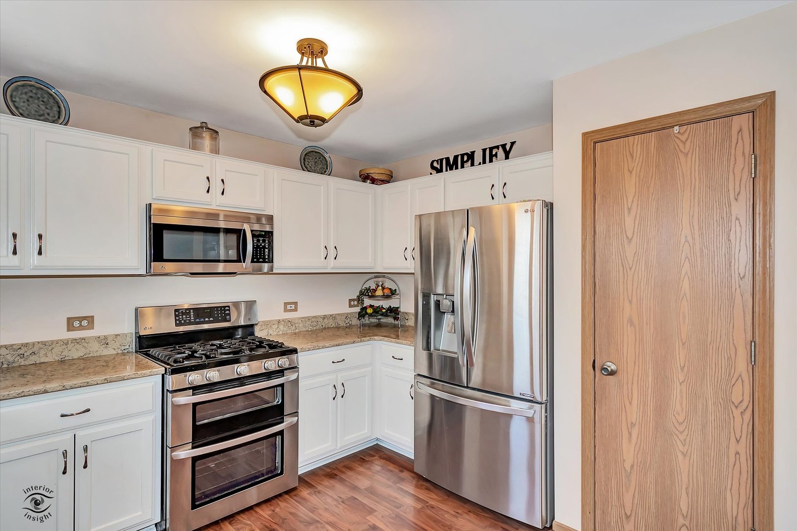 2909 Bisbee Drive Joliet, IL 60432 - Photo 8 of 23 a kitchen with stainless steel appliances granite countertop a refrigerator a stove and a sink with wooden floor