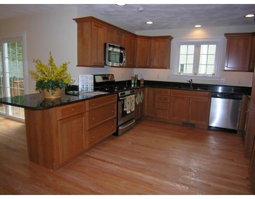 4 Knowles Farm Road Arlington, MA 02474 - Photo 2 of 12 a kitchen with stainless steel appliances granite countertop a stove a sink and a microwave