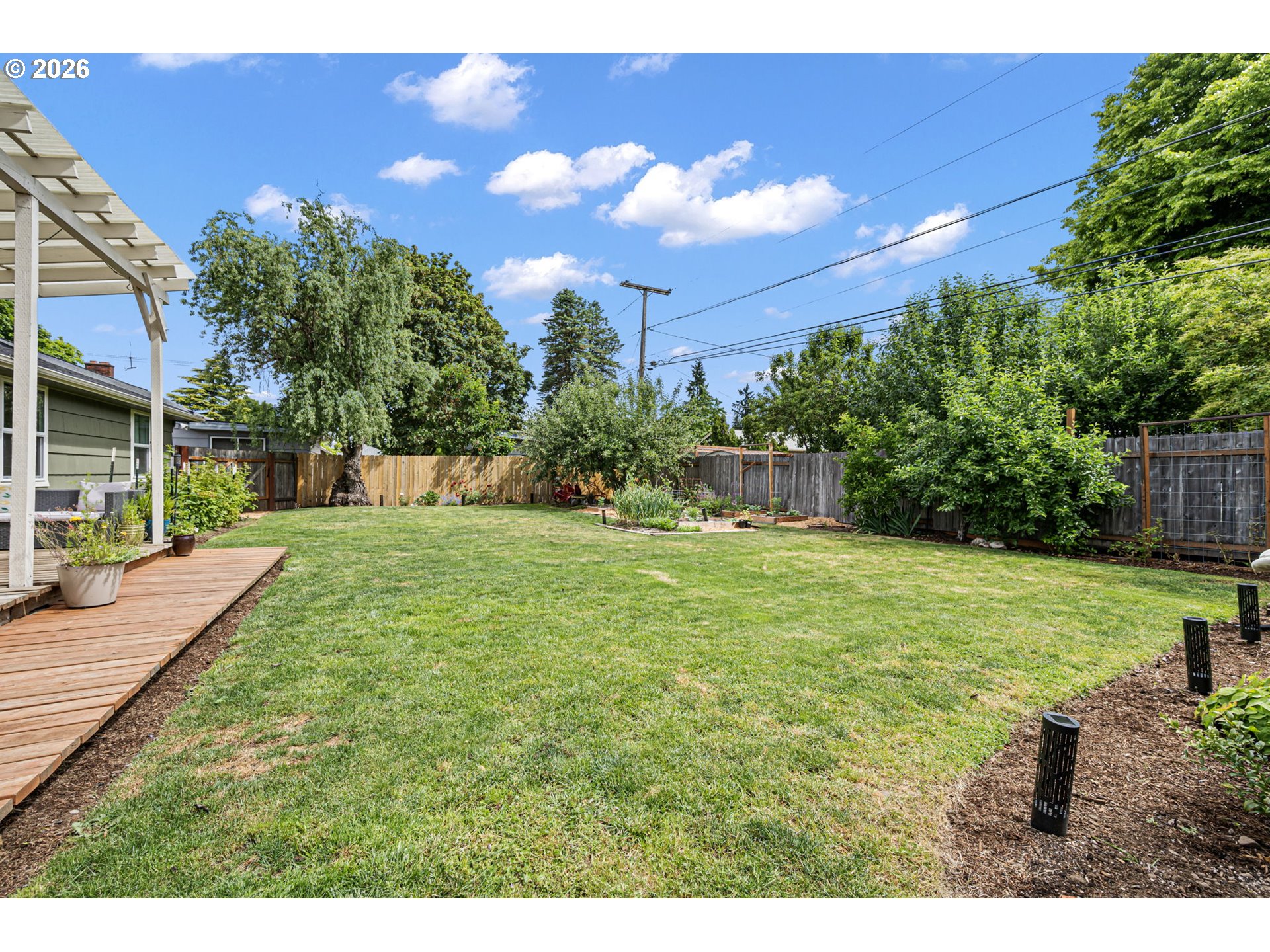 765 Louis Street Eugene, OR 97402 - Photo 36 of 45 a view of a backyard with a garden